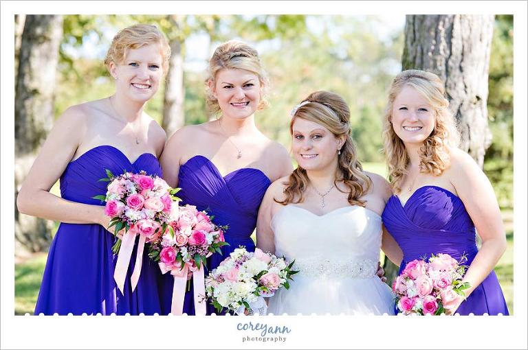 bridesmaids in purple dresses with pink bouquets