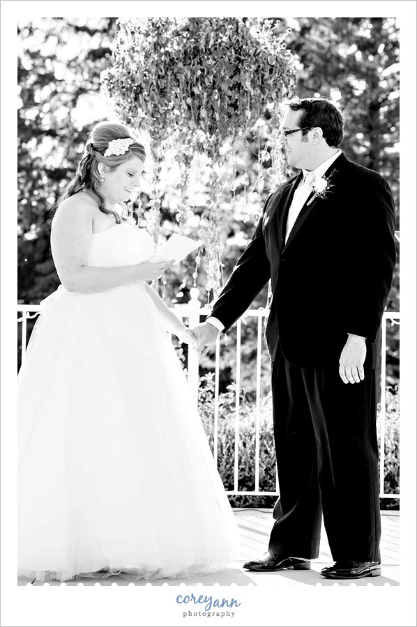 bride reading personalized vows during wedding ceremony