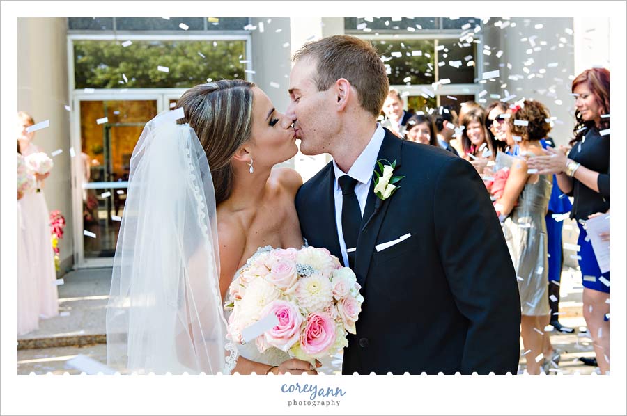 bride and groom exit with confetti cannon after wedding