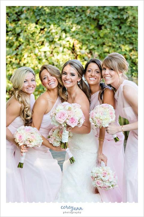 bridesmaids in pink dresses with pink bouquets