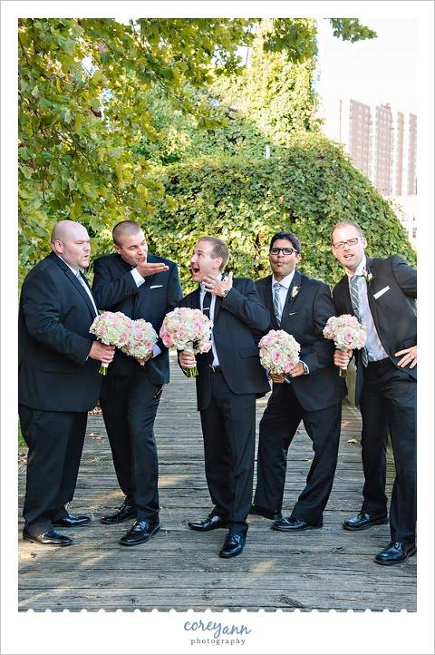 groomsman posing with bouquets