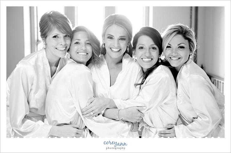 bride and bridesmaids in robes before wedding