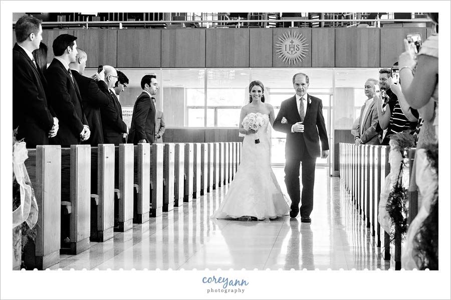 bride's father walking bride down aisle before wedding ceremony