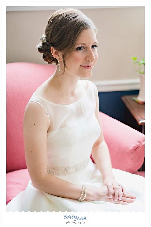 bride sitting in chair in tank style wedding dress