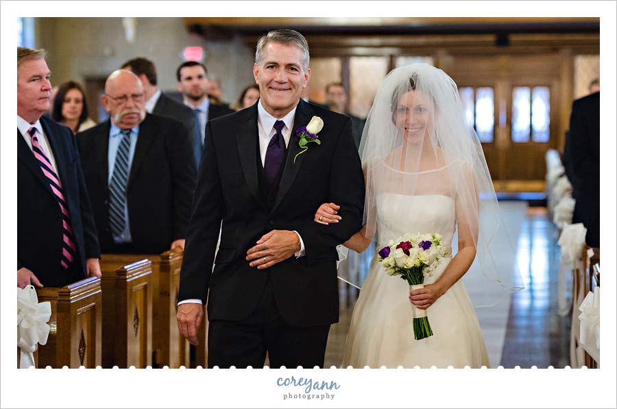 bride's father walking her down the aisle at st angela merici