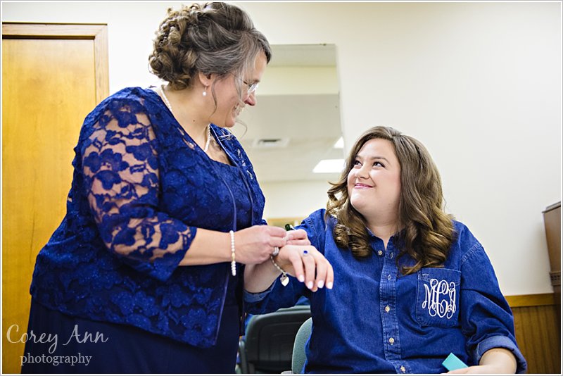 brides mother helping her get ready for wedding