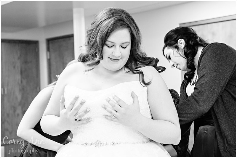 bride getting dressed before wedding at the old stone chapel in canton ohio