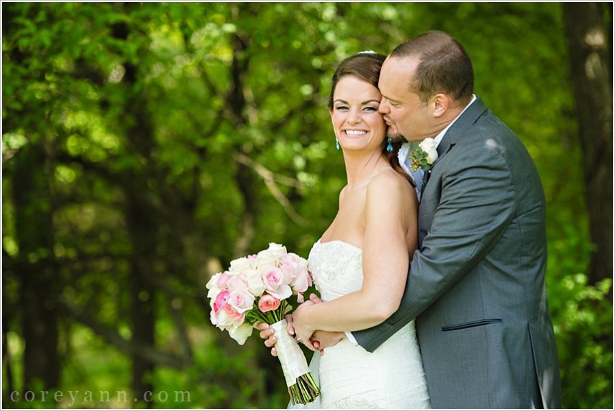 groom kissing bride on the cheek in akron ohio