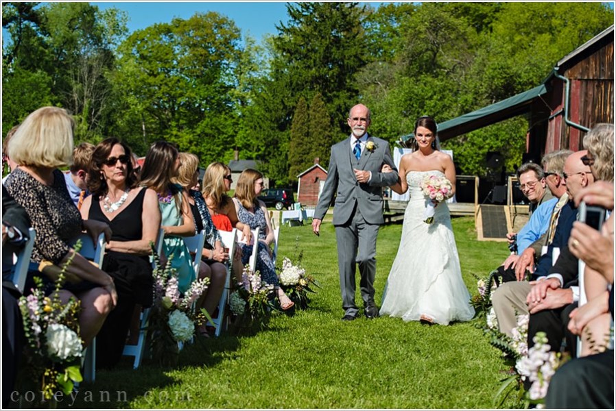 bride walking up the aisle with her father before wedding ceremony