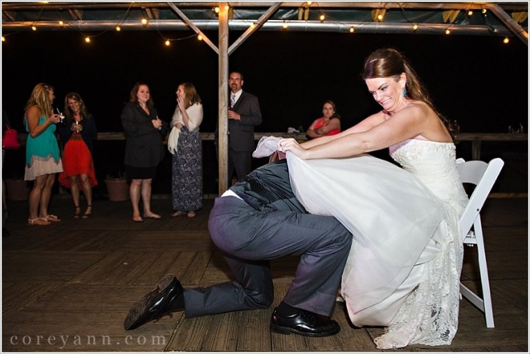 groom removing garter from bride during wedding reception in ohio