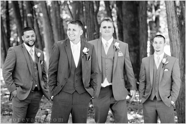 black and white groomsman photo in woods