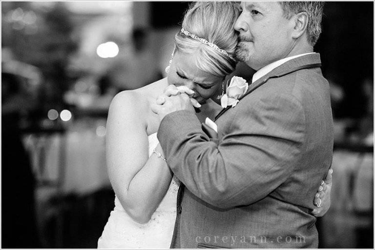 bride crying during father daughter dance at wedding reception