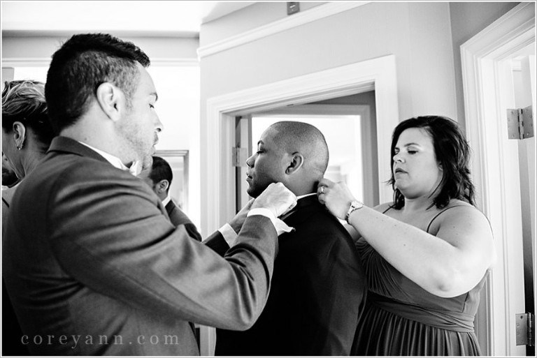 bridesmaid and groomsman getting ready together before wedding