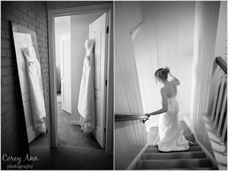 wedding dress hanging with mirror and bride after she gets ready