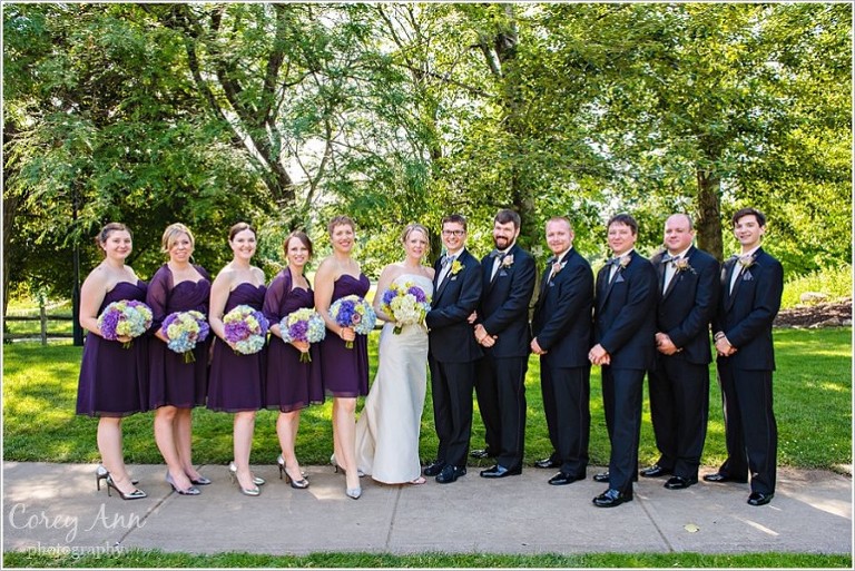 black and purple bridal party outside in june