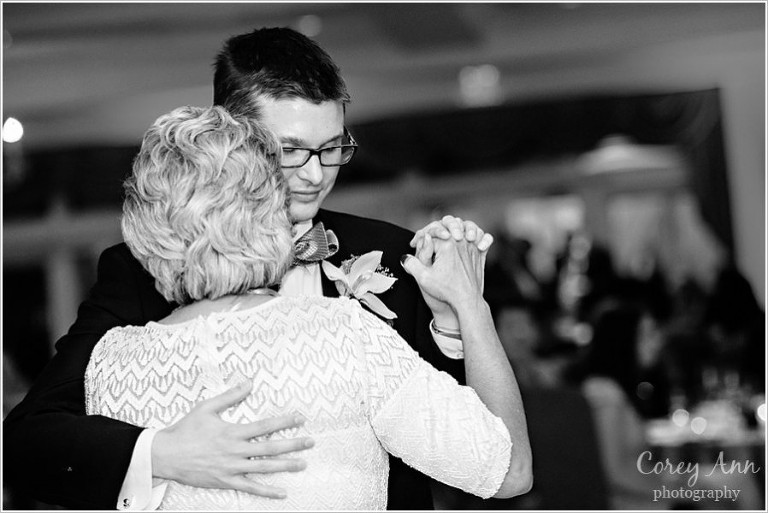 mother and son dance with the bottom line band at wedding reception 