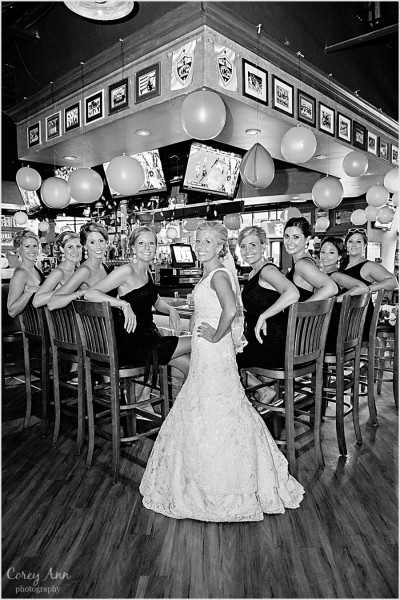 bride and bridesmaids pose in paninis bar in kent ohio