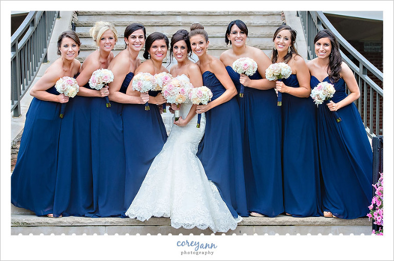 bridesmaids in long blue dresses with pink bouquets