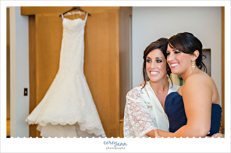 bride and bridesmaid getting ready at blessed sacrament church in warren ohio