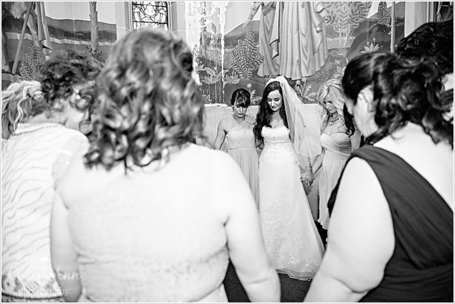 bride and bridesmaids praying before wedding