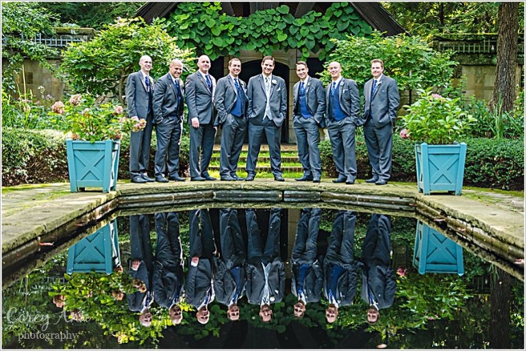 groomsman in reflecting pool at stan hywet hall and gardens