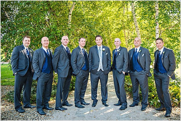 groomsman in grey suits with blue vests