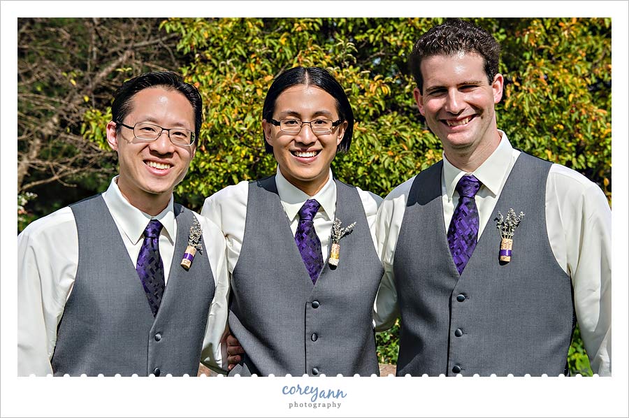 wedding groomsman with grey vests and purple ties