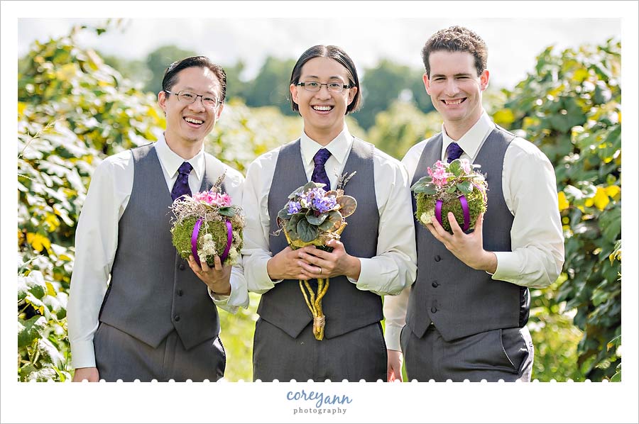 groomsman holding bouquets