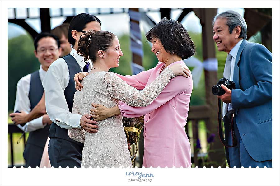 bride hugging her mother in law after wedding ceremony in ohio