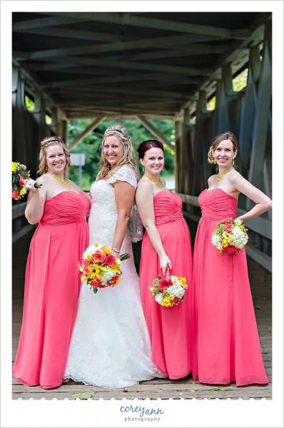 bridesmaids in pink dresses with yellow bouquets