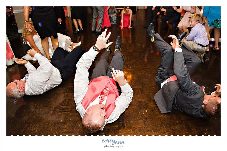 guests on the floor during shot song during wedding reception