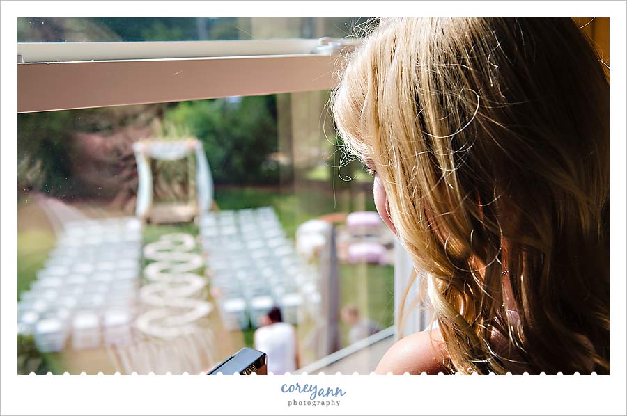 child looks out over backyard ceremony setup