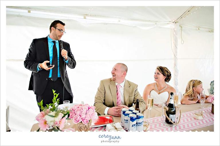 toast during wedding reception in tent outdoors