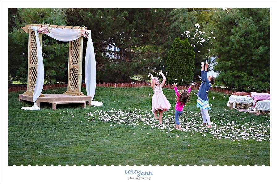 kids playing in rose petals during wedding reception in massillon