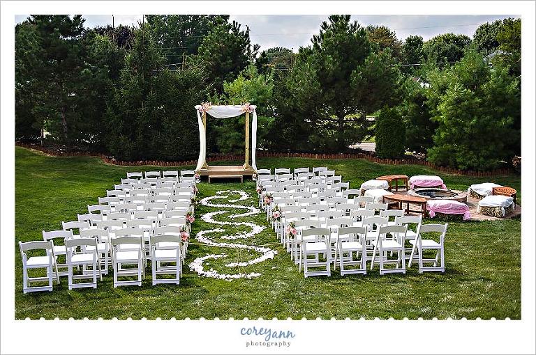 outdoor wedding with petal design in the aisle