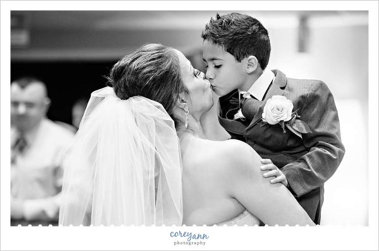 bride kissing son after wedding ceremony