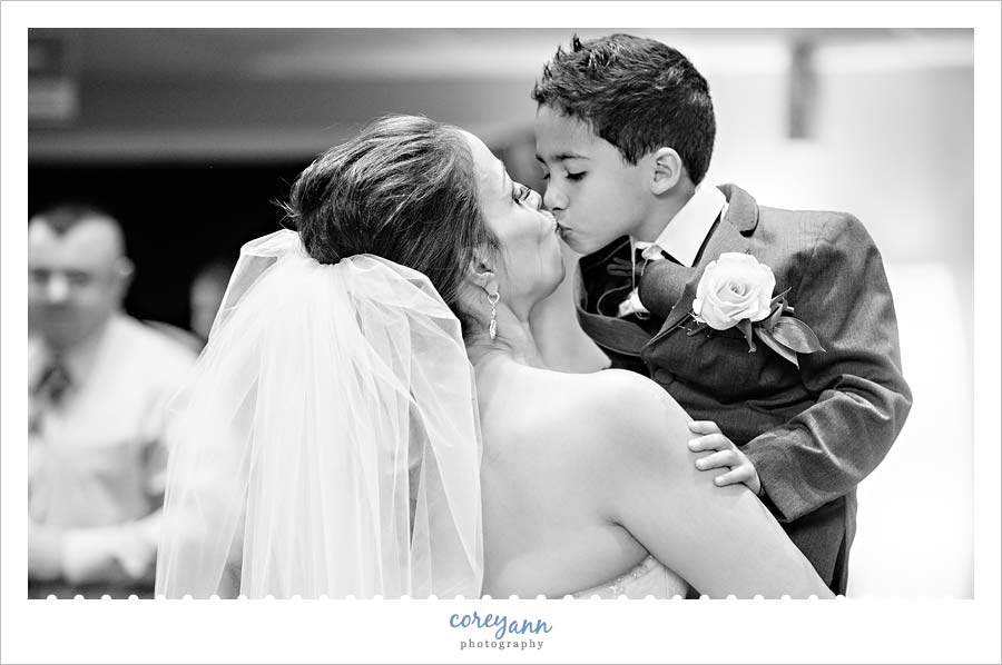 bride kissing son after wedding ceremony
