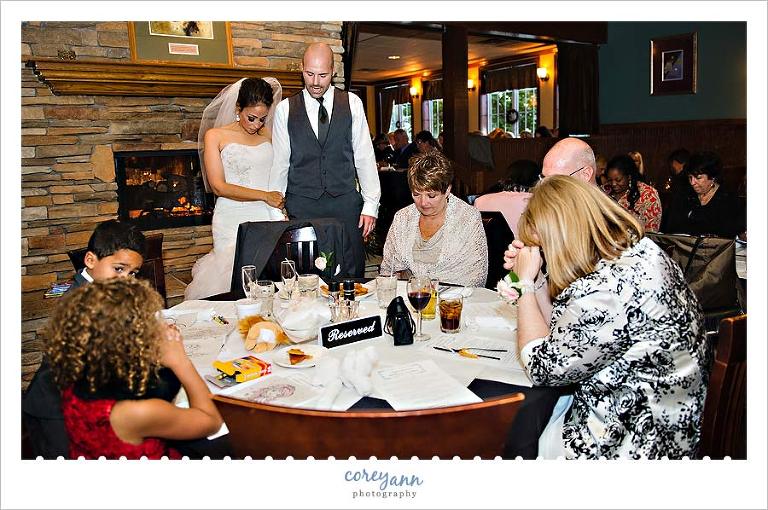 bride and groom praying before dinner at reception