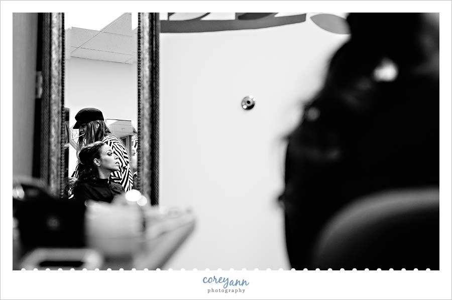 bride getting makeup done before wedding ceremony