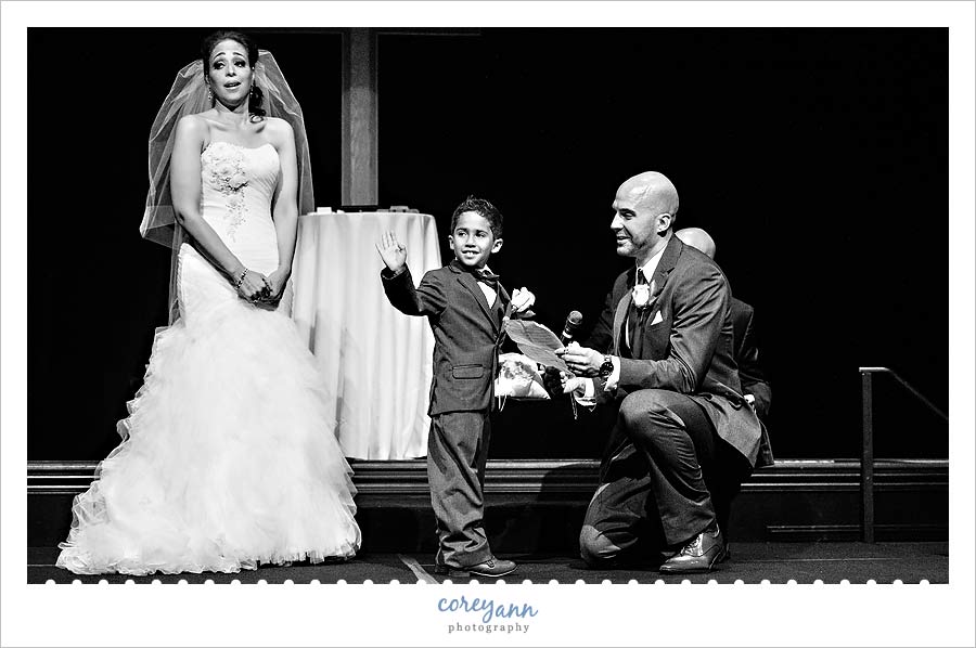 son waving to congregation during wedding ceremony