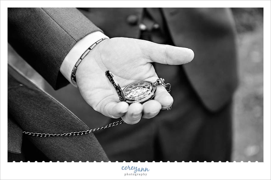groom showing pocket watch 