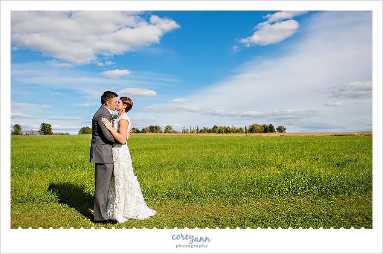bride and groom in field in ohio