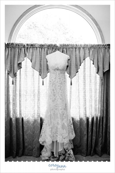 brides dress hanging up in window