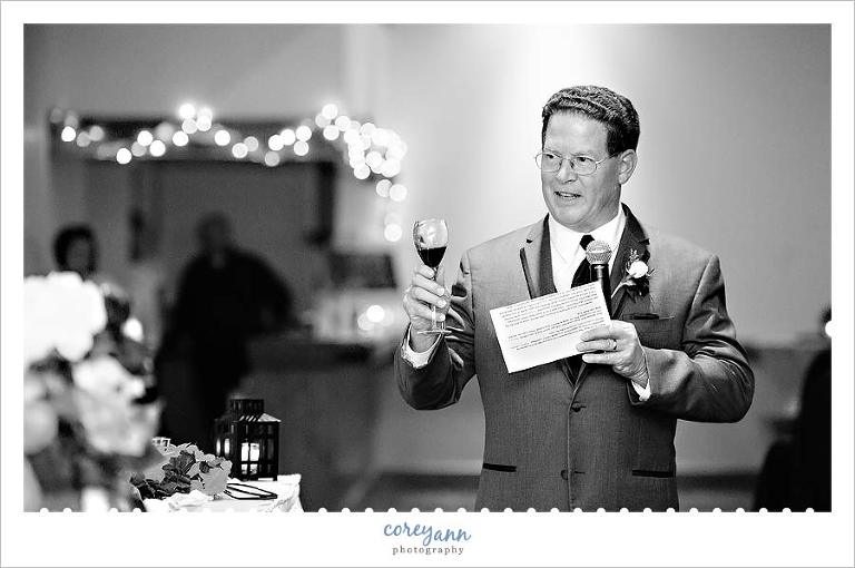 father toasting bride and groom at wedding