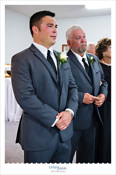 groom crying while bride walks up aisle during wedding ceremony in seville ohio