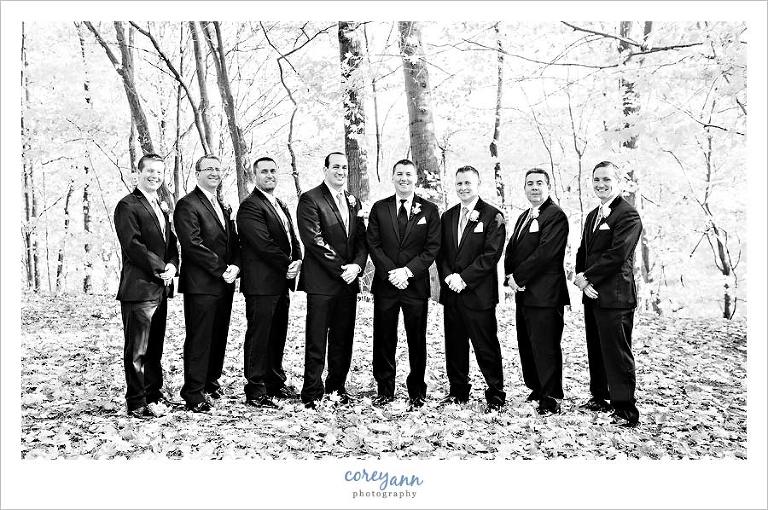 black and white portrait of groomsman in park