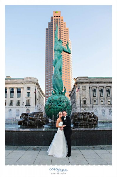 bride and groom wedding portrait in front of fountain in downtown cleveland