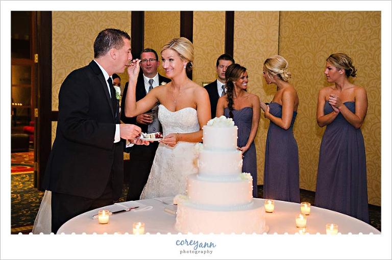 bride and groom cutting the cake at wedding reception