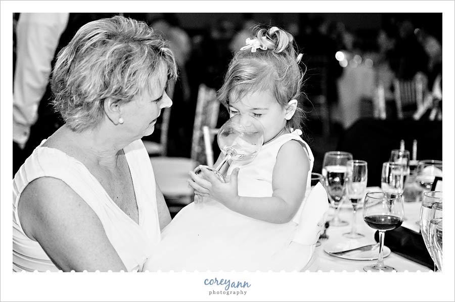 flower girl drinking out of wine glass