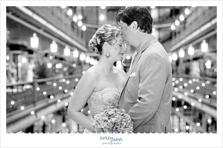 groom kissing bride on forehead before wedding in cleveland ohio